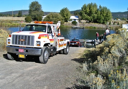 Chiloquin Towing: Pickup and trailer emerging from the river