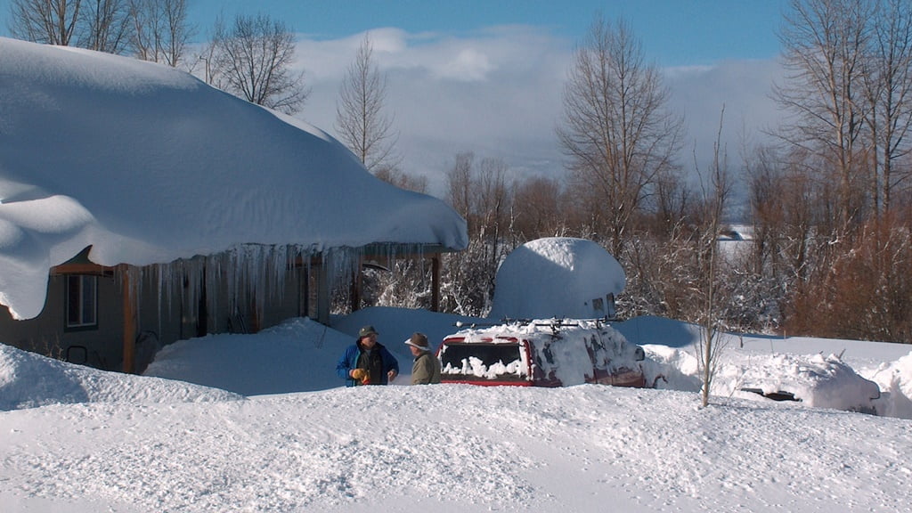 Neighbors chat after clearing enough snow to drive in and out, after a big storm for the Chiloquin area.